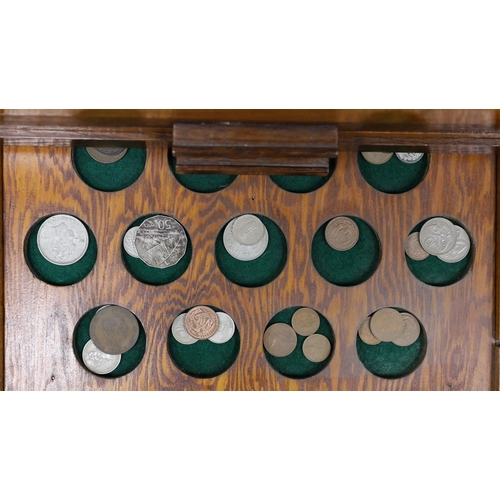 476 - A collection of mixed coinage in a collectors cabinet, 27cm tall