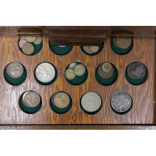 476 - A collection of mixed coinage in a collectors cabinet, 27cm tall