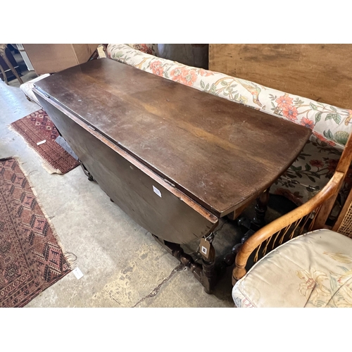 68 - An early 18th century style oak oval topped gateleg dining table, (one leaf in need of repair), leng... 