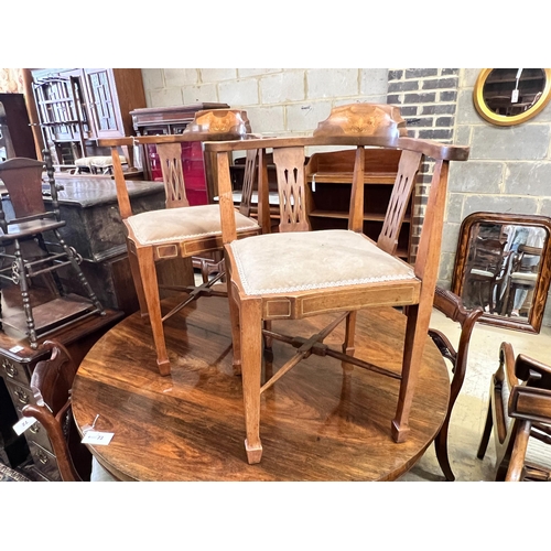 74 - A pair of Edwardian inlaid mahogany corner elbow chairs