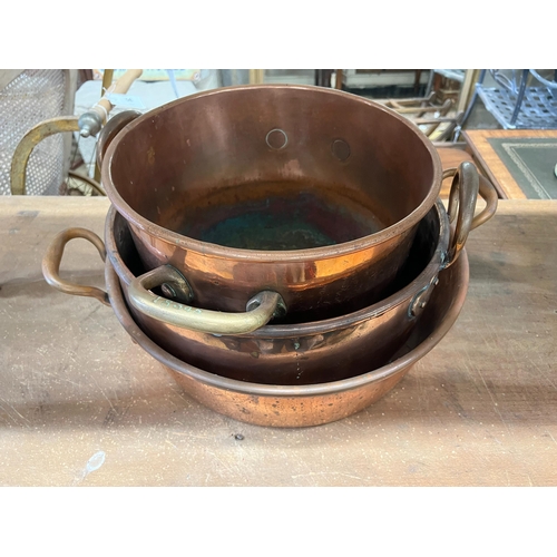 81 - Three Victorian circular copper two handled preserve pans, largest diameter 43cm