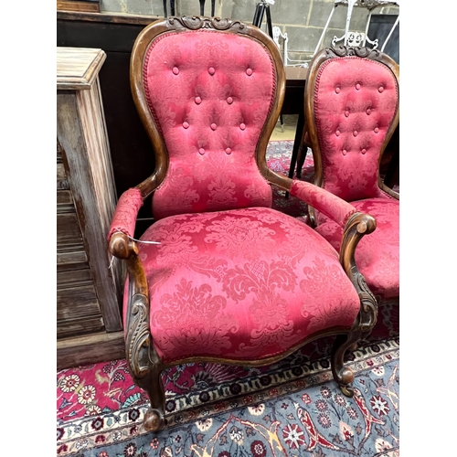 89 - A pair of Victorian walnut spoon back upholstered chairs, one with arms