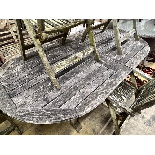 93 - A weathered teak oval extending garden table, extended 250cm, width 109cm, height 73cm, together wit... 