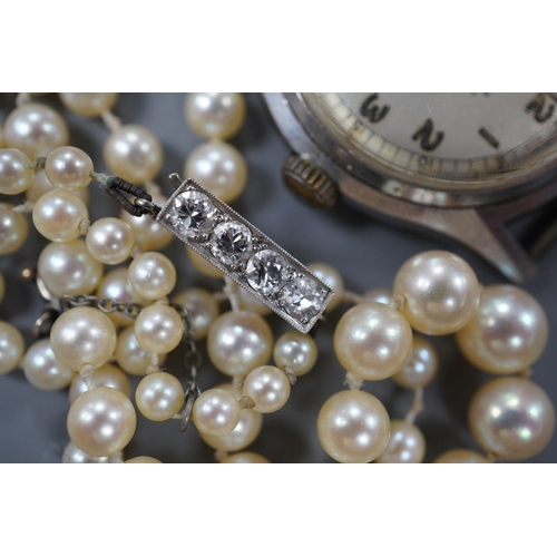 967 - A single strand graduated cultured pearl necklace, with four stone diamond set white metal clasp, 50... 