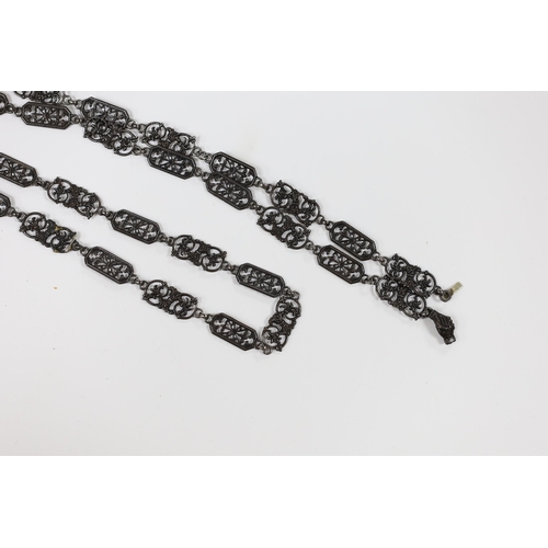 970 - A 19th century Berlin iron work long necklace, with pierced octagonal and scrolling links, the clasp... 