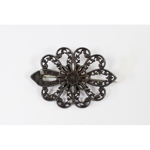 971 - A 19th century Berlin iron work brooch, of shaped oval flower head form (repair), 49mm.