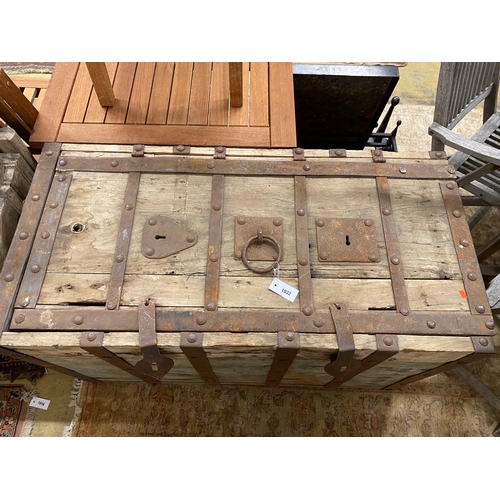 1032 - A large iron-bound rectangular wood Armada style chest, width 122cm, depth 61cm, height 74cm