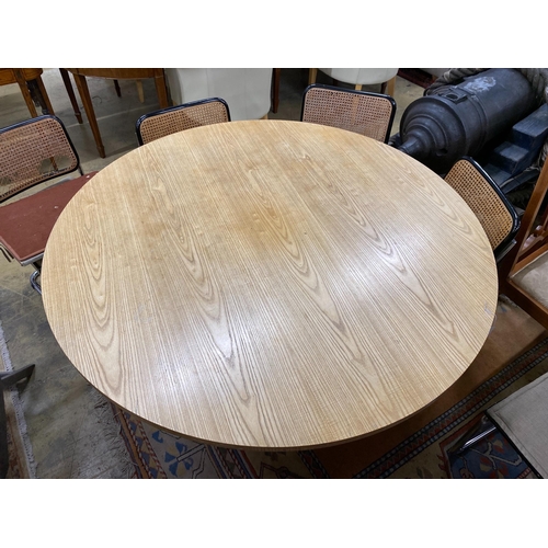 1035 - A Conran retailed circular pale ash dining table, on three pillars and circular plinth foot, diamete... 