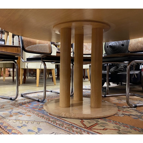 1035 - A Conran retailed circular pale ash dining table, on three pillars and circular plinth foot, diamete... 