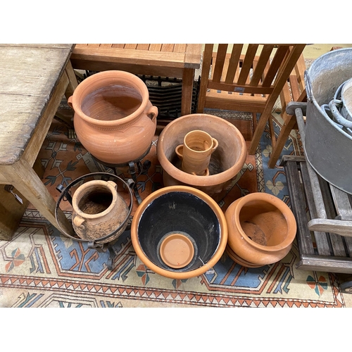 1070 - Eight assorted terracotta garden planters and two stands, largest diameter 49cm, height 40cm