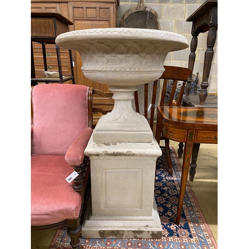 1077 - A faux stone circular garden urn on a square plinth, diameter 75cm, height 120cm