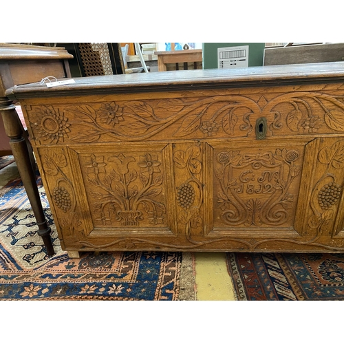 1101 - An 18th century and later carved oak coffer, length 134cm, depth 56cm, height 61cm