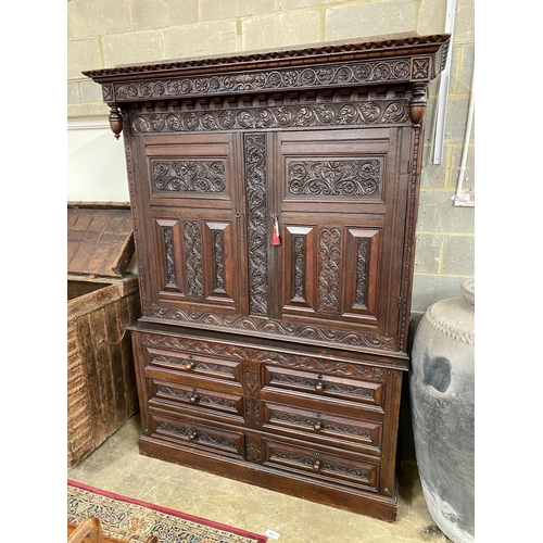 1136 - A large Flemish oak two part hanging cupboard, length 154cm, depth 55cm, height 219cm