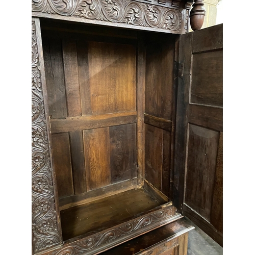 1136 - A large Flemish oak two part hanging cupboard, length 154cm, depth 55cm, height 219cm