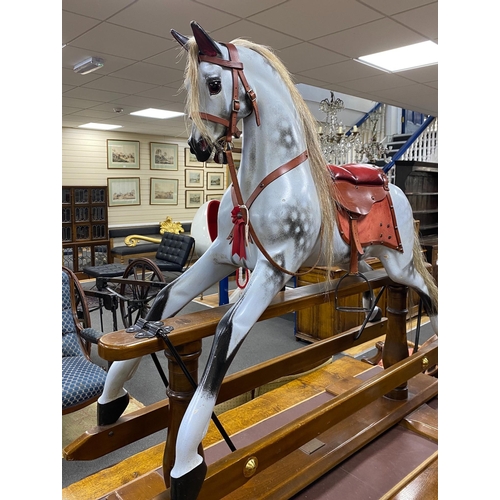 1159 - A Stevenson Brothers carved wood dapple grey rocking horse, with burgundy leather tack on beech safe... 