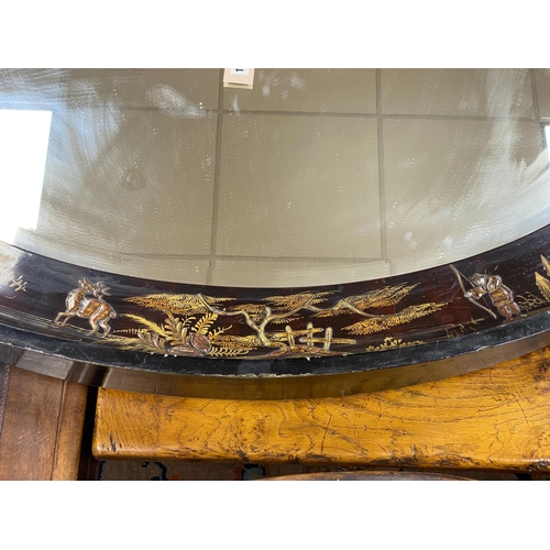 1160 - An early 20th century oval chinoiserie lacquered oval wall mirror, width 117cm, height 78cm