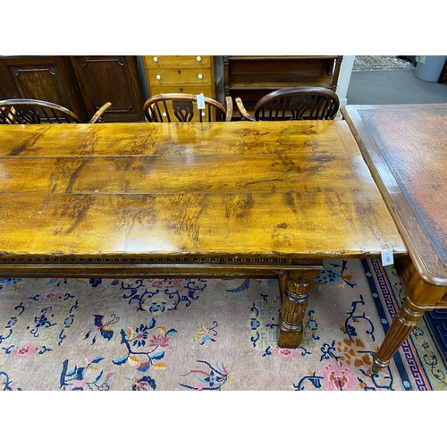 1163 - An 18th century style rectangular pale oak refectory dining table with central stretcher and two det... 