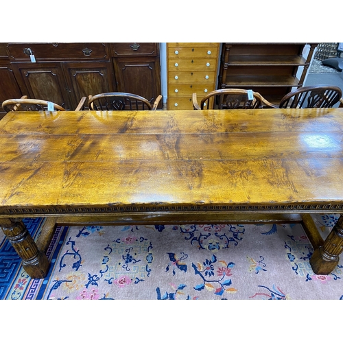 1163 - An 18th century style rectangular pale oak refectory dining table with central stretcher and two det... 