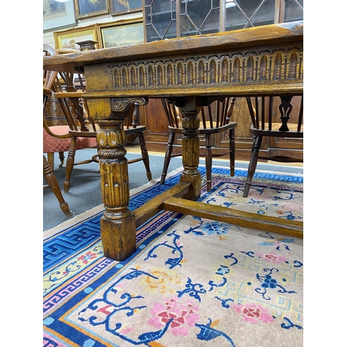 1163 - An 18th century style rectangular pale oak refectory dining table with central stretcher and two det... 