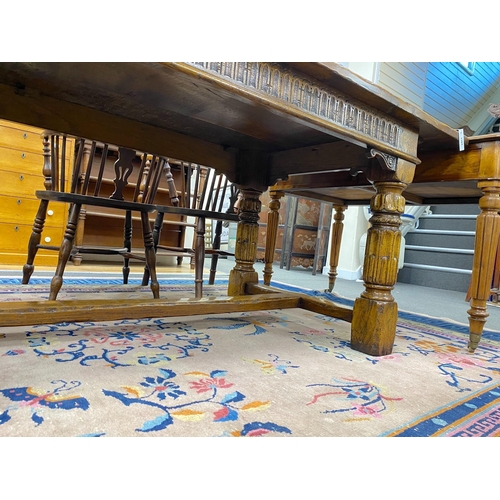 1163 - An 18th century style rectangular pale oak refectory dining table with central stretcher and two det... 