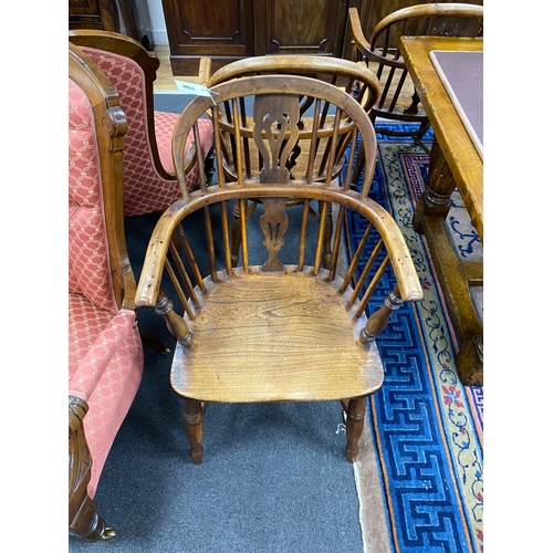 1164 - A pair of mid 19th century yew and elm Windsor elbow chairs, with crinoline stretchers, width 55cm, ... 