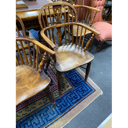 1165 - A near pair of mid 19th century yew and elm Windsor elbow chairs, with crinoline and H stretcher, la... 