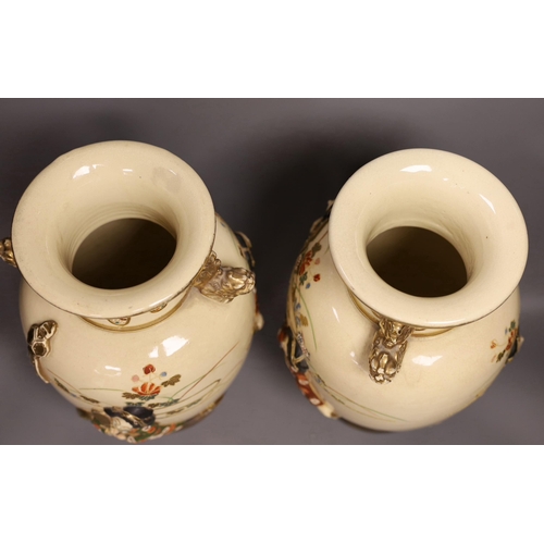 1299 - A pair of large Satsuma vases with relief decoration and dragon handles, 35cm tall with bases