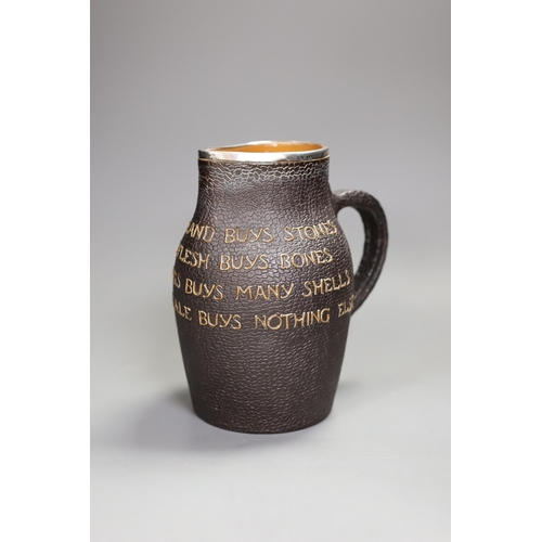 1329 - A Doulton Lambert black jug, 'He Who Buys Good Ale Buys Nothing Else', with silver mount, 19cm tall... 