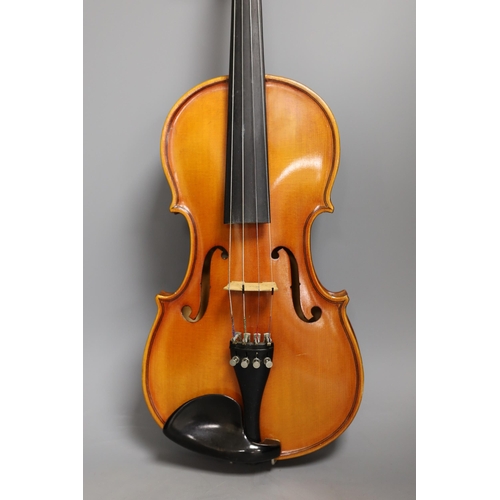 1379 - A cased child's violin and bow with ivorine tip,  violin 55cms long,