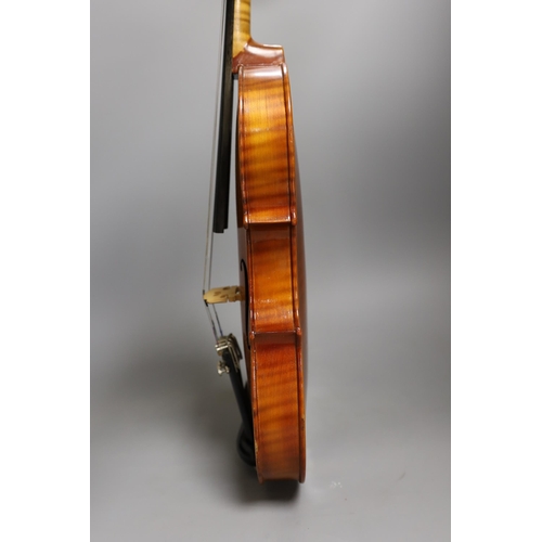 1379 - A cased child's violin and bow with ivorine tip,  violin 55cms long,