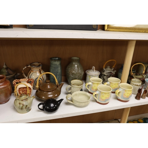 1402 - A large quantity of British studio pottery teapots, mugs, jugs and other miscellaneous items, to inc... 