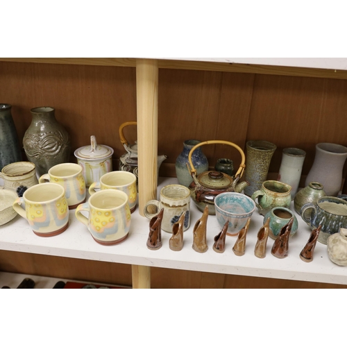 1402 - A large quantity of British studio pottery teapots, mugs, jugs and other miscellaneous items, to inc... 