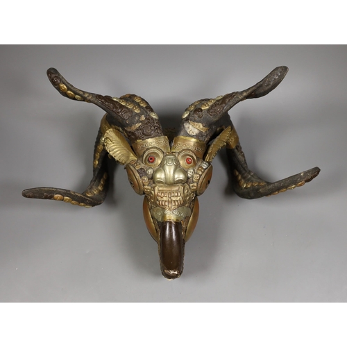 1430 - A Buddhist decorated ram's skull with brass decor, 20cm tall