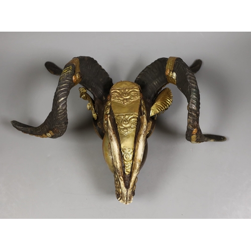 1430 - A Buddhist decorated ram's skull with brass decor, 20cm tall