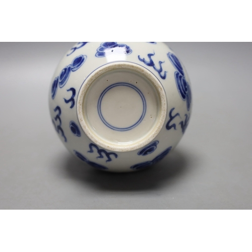 1467 - A Chinese  blue and white dragon and phoenix bottle vase, 23 cms high.