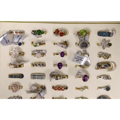 1915 - Fifty assorted modern gem set dress rings, to include thirty six 9ct gold rings including diamond se... 