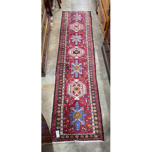 1019 - A Caucasian style red ground runner, 264 x 63cm