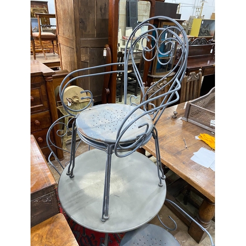 1049 - A circular wrought iron garden table, diameter 70cm, height 71cm together with four wrought iron gar... 