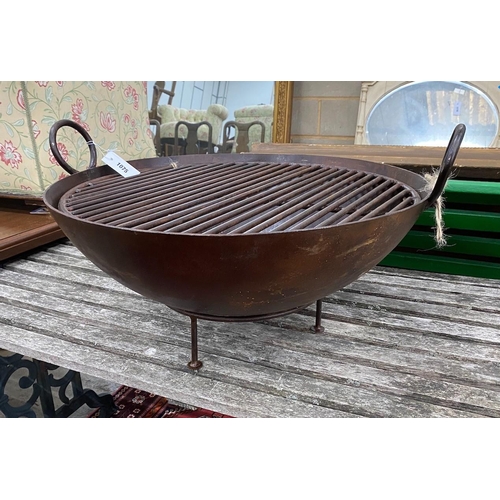 1075 - A circular wrought iron fire-pit on low stand, diameter 82cm, height 38cm