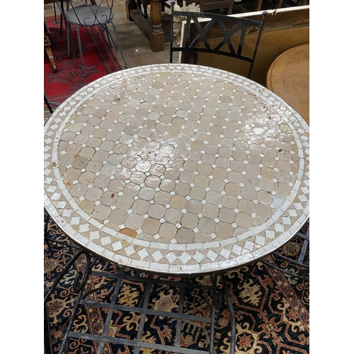 1089 - A circular mosaic top wrought iron garden table, diameter 100cm, height 74cm together with four wrou... 