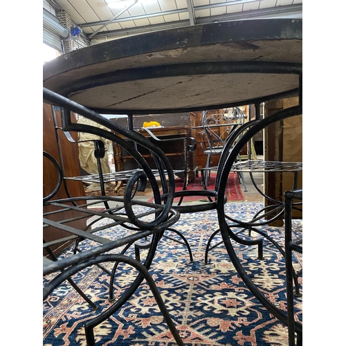 1089 - A circular mosaic top wrought iron garden table, diameter 100cm, height 74cm together with four wrou... 