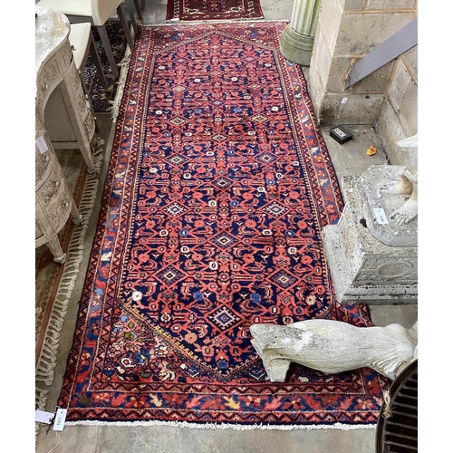 1093 - A North West Persian blue ground hall carpet, 304 x 127cm