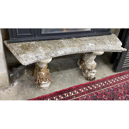 1119 - A reconstituted stone curved garden seat on dolphin supports, length 144cm, depth 33cm, height 49cm ... 