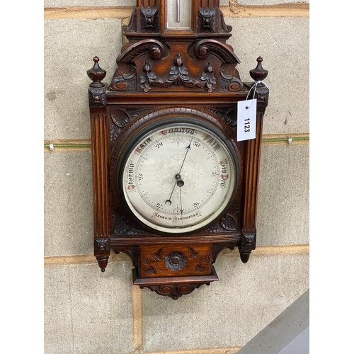 1123 - A late Victorian carved walnut aneroid barometer and thermometer, height 95cm