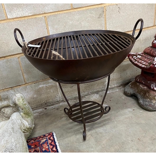 1125 - A circular wrought iron fire pit on stand, diameter 64cm, height 63cm