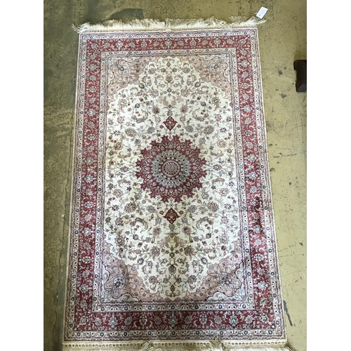 1139 - A Tabriz ivory ground part silk rug with central floral medallion, 150 x 95cm