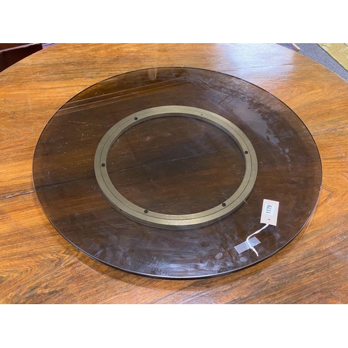 1179 - A contemporary smoked glass 'Lazy Susan', diameter 71cm