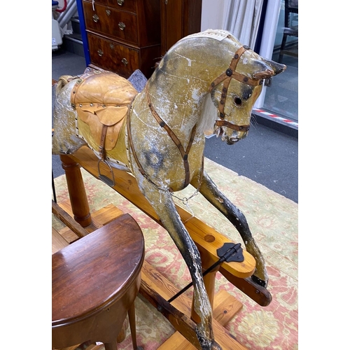 1184 - An early 20th century Ayers type dapple rocking horse with tan leather tack on pine safety frame, le... 