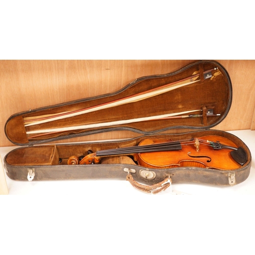 1283 - A 19th century violin labelled JB Guadagnini, back measures 35cm, with two bows, one silver-mounted.... 