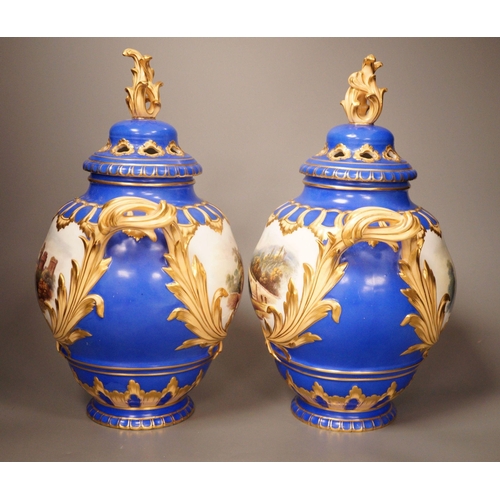 1356 - A pair of English bone China lidded two-handled vases, painted with river landscapes, within blue an... 